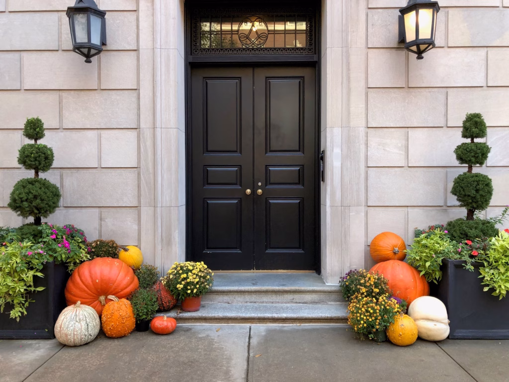 Fall pumpkin display outside a historic Savannah-style townhouse entrance