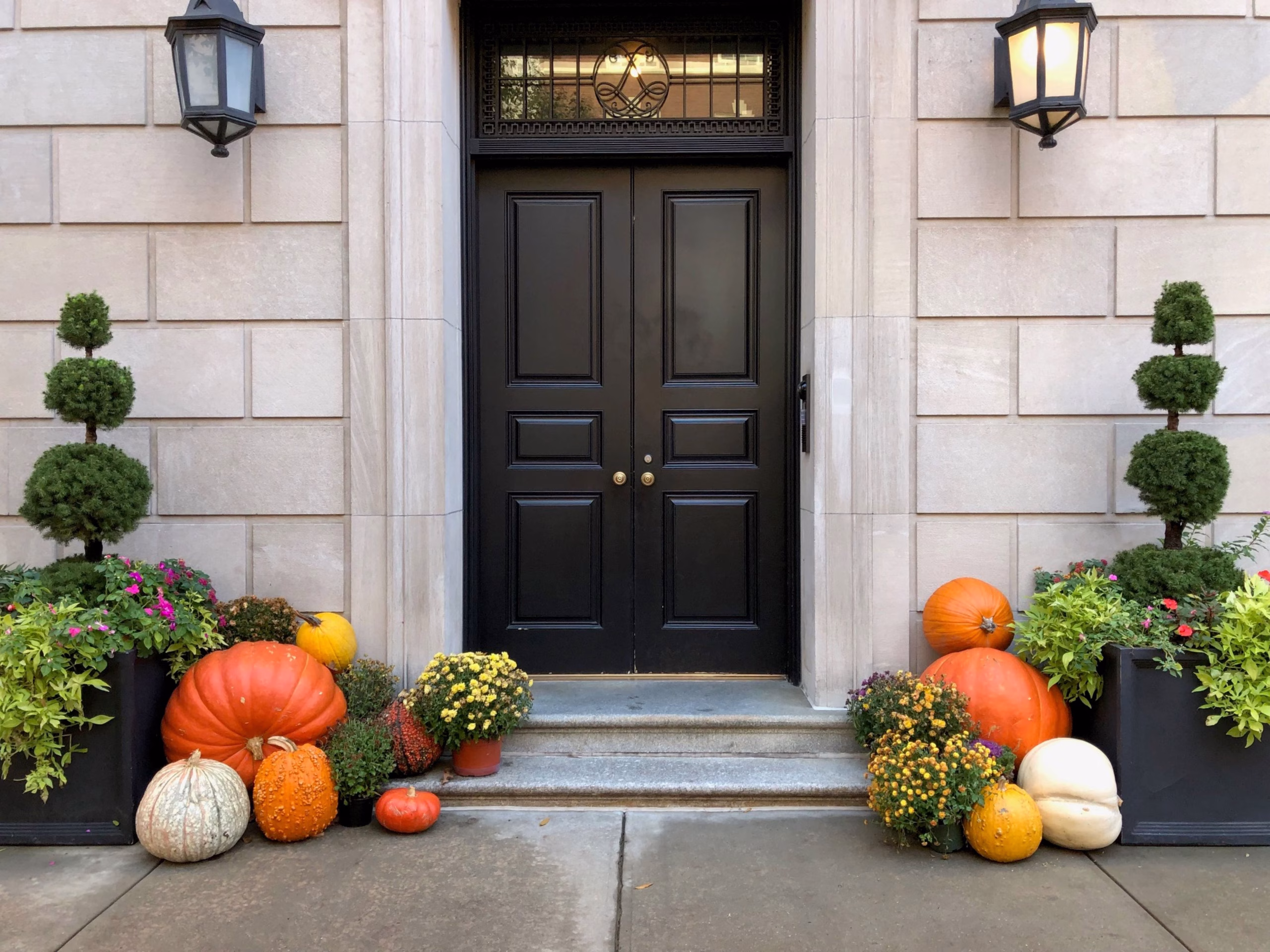 Fall pumpkin display outside a historic Savannah-style townhouse entrance